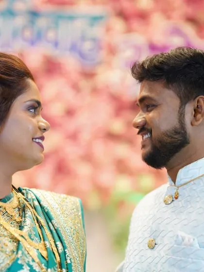 A sweet moment between the couple at their reception. Both bride and groom look happy and radiant.