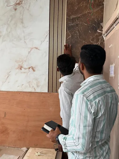 My team and I ensuring the precise alignment of the decorative wall panels during installation.