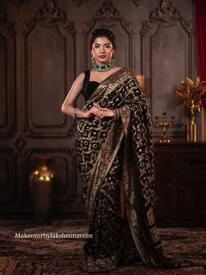 This elegant look with a black saree and green jewelry is a perfect example of classic styling that I teach my students.