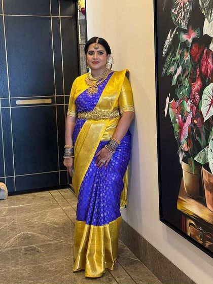 Another beautiful portrait of Priya, her royal blue and gold saree a perfect choice for a grand occasion.