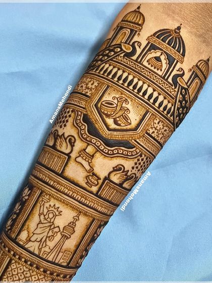The full view of a custom bridal arm band. It blends traditional Indian wedding symbols like the dhol and peacocks with international landmarks for a truly personal touch.