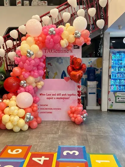 A vibrant balloon arch in pink, yellow, and red created for a corporate "TAGentine's" event. This shows how I can customize themes for office celebrations, making them fun and engaging for employees.