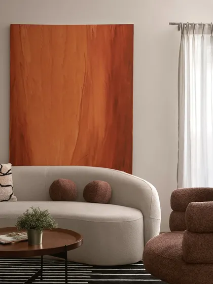 This living room showcases my love for minimalist earthy decor. The design uses soft, organic curves in the furniture and a warm, muted palette anchored by a bold terracotta art piece, creating a space that feels both sophisticated and deeply comforting.