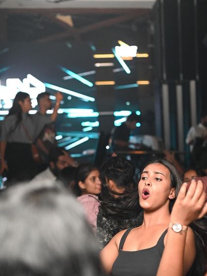 A partygoer singing along to their favorite track.