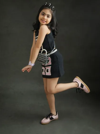 A playful and stylish pose that's perfect for a kid's fashion portfolio.