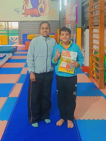 A proud student and coach pose with a new certificate.