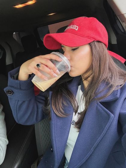 A candid shot of drinking coffee in the car.