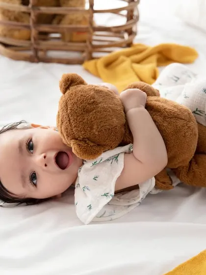 Cuddles with a favorite teddy bear. Including a special toy can make the session even more personal and result in sweet, candid moments.