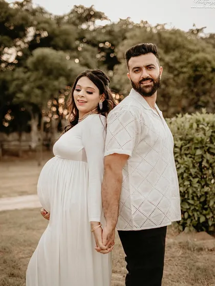 Capturing the quiet joy and connection between partners is one of my favorite things. This outdoor couple's portrait, shot in soft natural light, is all about the love and anticipation you share.