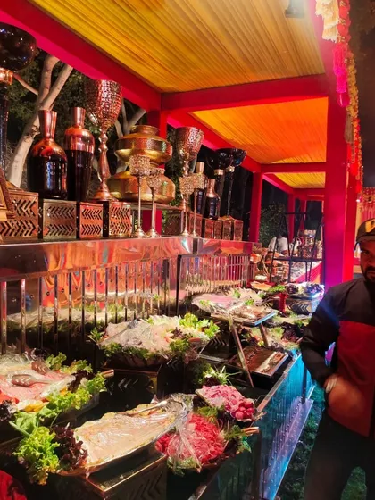 A closer look at the colorful salad bar under festive red and yellow lighting. The display showcases the freshness and variety of ingredients I use for my vegetarian catering services.