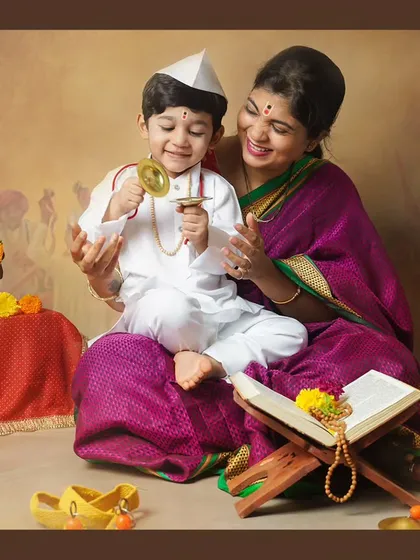 A mother and son sharing a beautiful moment during our Varkari themed shoot, passing on cultural traditions.