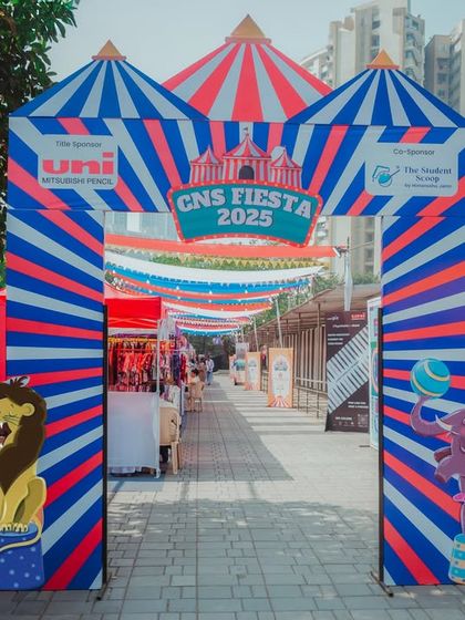 The main entrance to the CNS Fiesta 2025, a large-scale school carnival. The classic red, white, and blue striped arch with circus animal cutouts created a grand welcome.