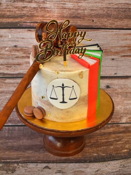 Order in the court. This cake is for a lawyer's birthday, featuring the scales of justice, law books, and a judge's gavel, all crafted from fondant.
