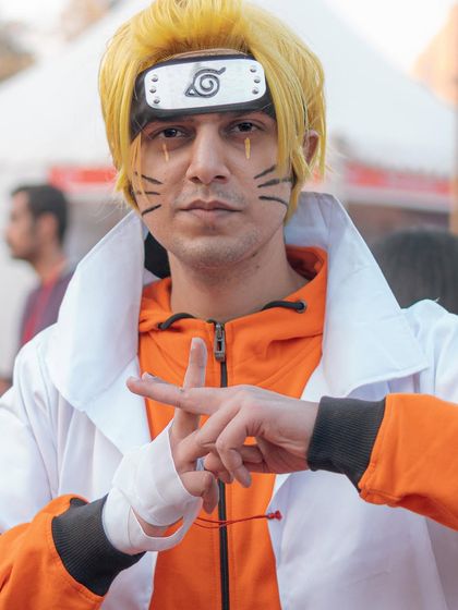 A cosplayer in full Naruto Sage Mode attire, making a classic hand sign for a jutsu. I work with cosplayers to get poses that are true to their characters.