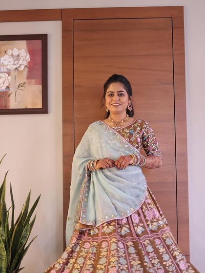 A beautiful, soft makeup look for a pre-wedding event. The earthy tones of the lehenga are complemented by natural, glowing makeup.