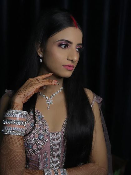 A side profile of the reception bride, showing her elegant hairstyle and diamond jewelry.