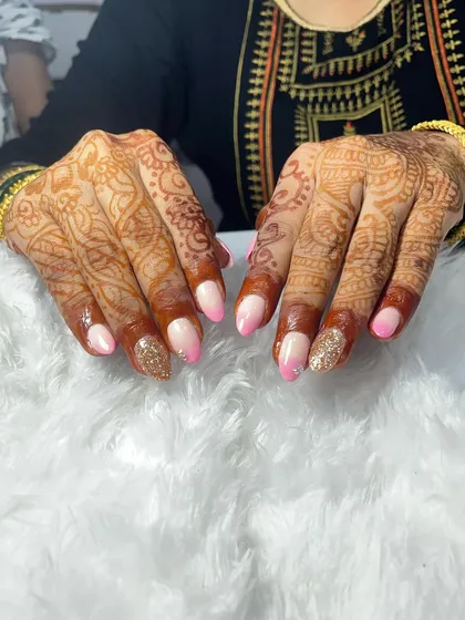 This bridal set combines two of my favorite techniques: a delicate pink ombré and a full coverage gold glitter nail. I used temporary extensions to add length and create a uniform, elegant shape for her special occasion.
