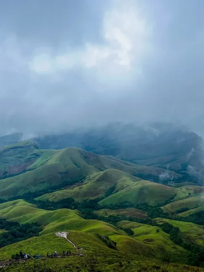 As you climb higher, the clouds often roll in, creating a magical, misty atmosphere over the Kudremukha valleys. It's a truly immersive nature experience.