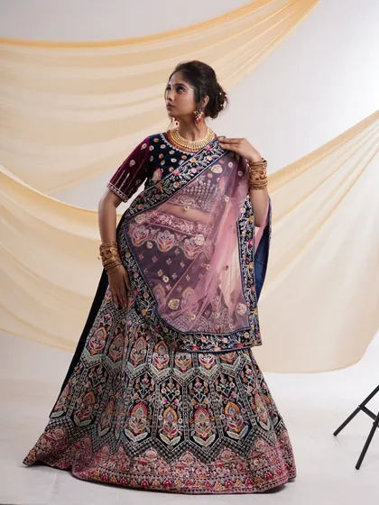 Another angle of the navy blue lehenga, highlighting the flow of the skirt and the elegant drape of the dupatta.