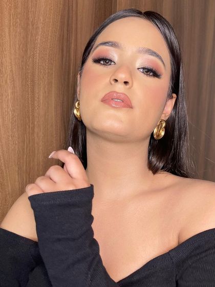 A powerful pose showing off this dewy, glamorous makeup. The skin looks luminous, and the soft eye makeup adds just the right amount of definition.