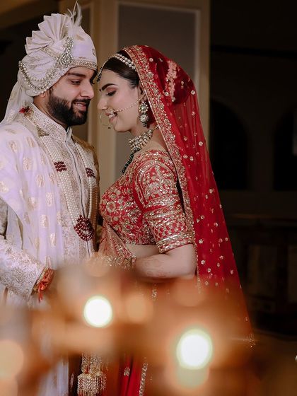 An intimate wedding portrait with soft, foreground bokeh. This technique creates a dreamy, romantic feel and draws all the attention to the couple's loving expressions.