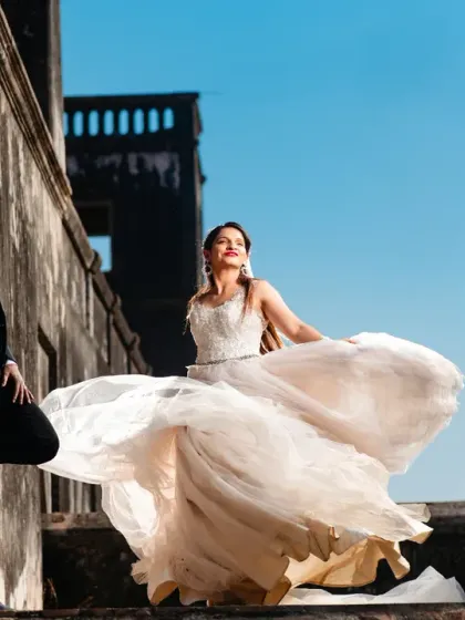 The bride's dress in full flight against the backdrop of historic ruins. This dynamic shot captures a feeling of joy and movement, blending modern energy with a timeless setting.