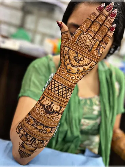This bridal back-hand design extends up the arm, showcasing bands of different patterns including swans, checks, and a personalized initial 'D'.