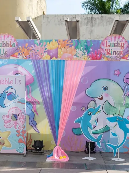 A beautifully illustrated backdrop for an Under the Sea party, featuring dolphins, seahorses, and jellyfish, creating a perfect setting for game stalls.