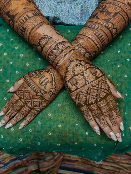 A crossed-hands pose showing the beautiful symmetry of this traditional elephant and initial design.