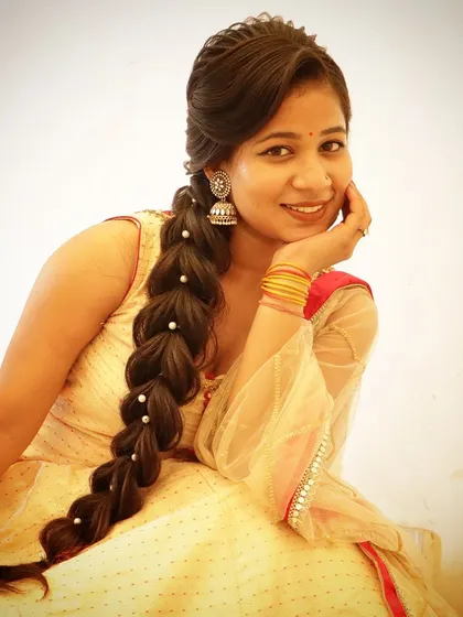 A beautiful cells braid hairstyle, which can also be played as a back braid. This is a unique and intricate style, shown here on a model for a wedding day occasion.
