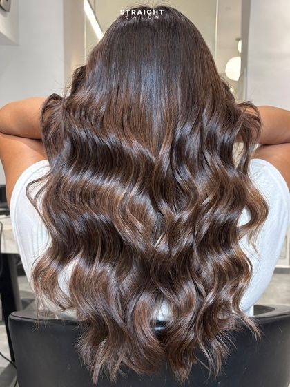 Balayage done right. Here, rich chocolate tones melt into soft, dimensional waves for a sophisticated and modern look.