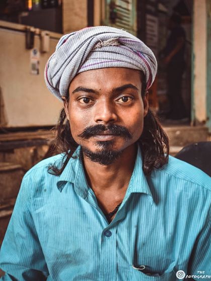 This man's distinct look, with his turban and mustache, makes for a compelling portrait. I aim to capture the unique identity of each person I photograph on the streets.