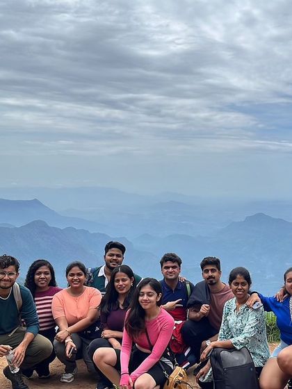 A beautiful group photo with a panoramic view of the Kodaikanal mountain ranges.