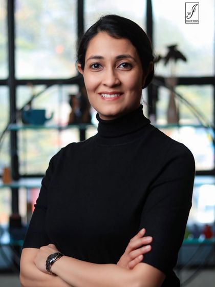 A warm and approachable headshot with a genuine smile, perfect for client-facing professionals.