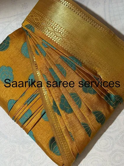 A yellow saree with blue polka dots, a fun and vibrant choice.
