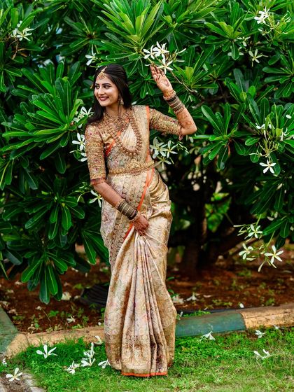 My beautiful client-turned-family, Chethana, looks timeless in this white and pink Kanchipuram saree. I designed a heavily handcrafted bridal blouse with intricate zardozi work to complement the saree's elegance for her special day.