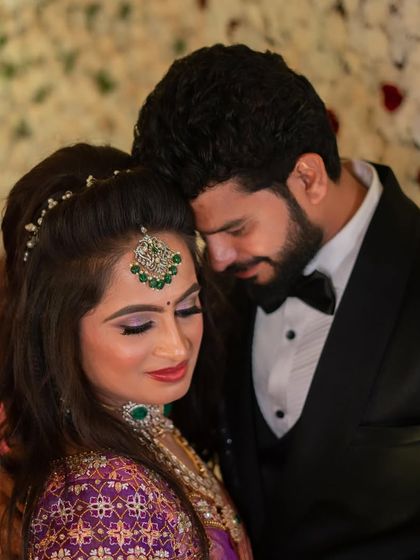 An intimate moment between the couple. This photo beautifully captures the romantic and glamorous feel of the reception look.