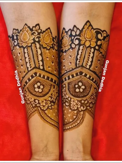 The beginning of an engagement mehendi design, featuring beautiful lotus bands on the arms. This creates a lovely cuff effect.
