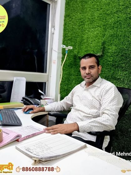 A photo of me, Rajkumar Nayak, at my desk, ready to manage your Karwa Chauth bookings.