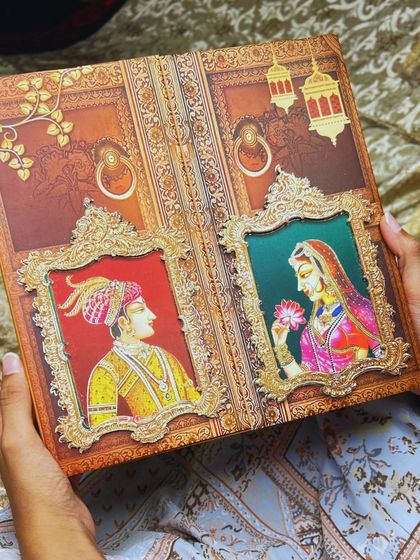 A shot of the miniature portrait invitation being held, showcasing its interactive and personal nature. It's a card that invites you to engage with it.