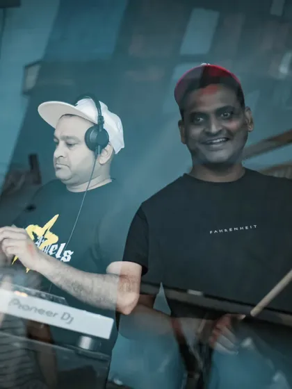 A candid shot of the Tribal Brothers in action. I'm lining up the next track while my partner, drumsticks in hand, is ready to add that live percussive punch that makes our sets so dynamic.