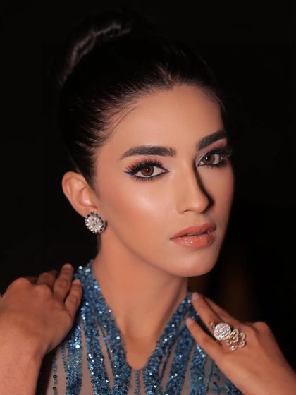 A beautiful portrait highlighting the intricate beadwork and the model's stunning features.