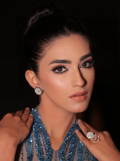 A close-up on the model's flawless makeup. The styling is sophisticated and modern, perfect for an evening gala.