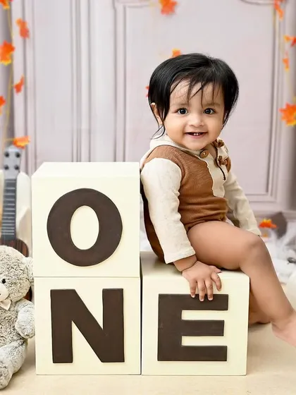 A sweet and classic sitter portrait. Leaning against his "ONE" blocks, this little boy's gentle smile is simply heartwarming.