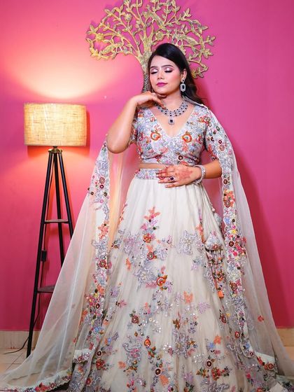 A full view of the white floral lehenga, showing the beautiful cape sleeves and detailed embroidery.