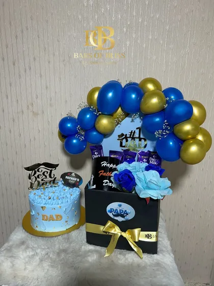 For the number one dad, this striking blue and gold themed Father's Day set includes a custom cake and a large hamper box. The hamper is filled with his favourite chocolates and decorated with a balloon arch and flowers.