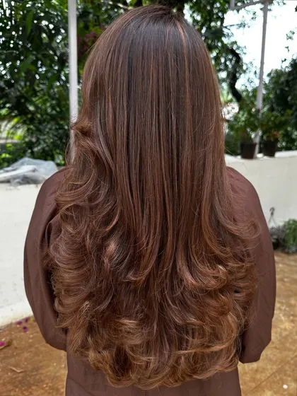 A beautiful color refresh for this client, getting her vacay-ready. I added soft, natural-looking highlights to her long hair and finished with a layered cut and bouncy curls for a glamorous feel.