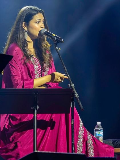 A full-length view of Priyanka Barve's stage outfit, showing the graceful flow of the ethnic wear.