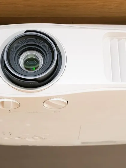 A close-up of a high-performance BenQ projector, ceiling-mounted for a clean installation. We use top-tier brands like BenQ, Sony, and Optoma to ensure our clients get the best possible image clarity and reliability for their presentations and events.