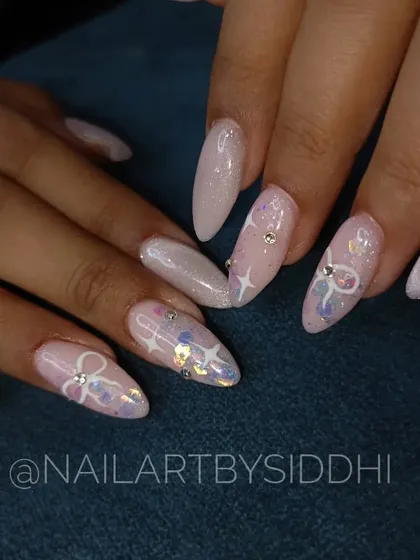 A soft, shimmery pink set with delicate bow designs, stars, and scattered crystals for a touch of sparkle.